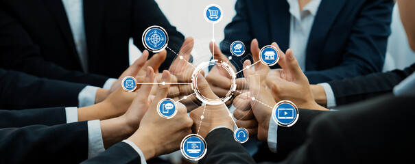 A dynamic visual representation of diverse business individuals collaborating, showcasing hands joined in unity around technology icons, symbolizing digital connectivity and innovation. Amity