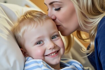 Mother kisses smiling child in hospital bed  