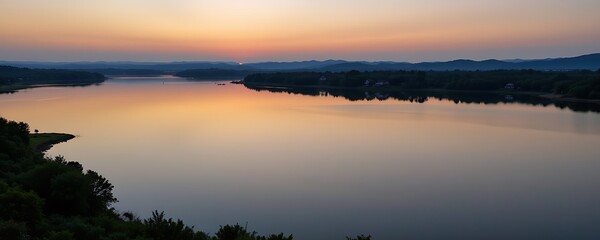 Fototapeta premium aerial view of a peaceful lake at sunrise, smooth reflection of sky on water
