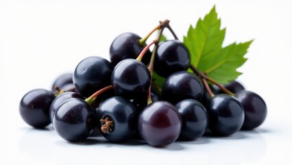 Fototapeta premium A heap of fresh blackcurrants lies against a white background, accentuated by vibrant green leaves