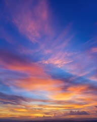 Obraz premium A stunning sunset with vibrant hues of orange, pink, and purple blending into a deep blue sky, creating a serene and picturesque view