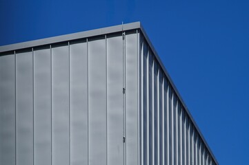 Modern building exterior with metal cladding against blue sky