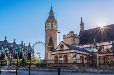 Morning sun lights up the iconic Big Ben and Westminster Abbey, capturing the essence of London's historic architecture and vibrant cityscape.