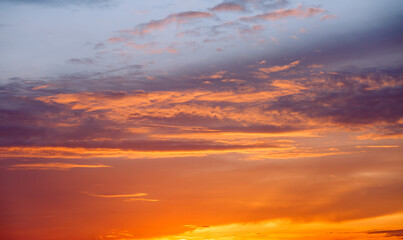 Gorgeous sunset fills the sky with hues of orange and purple, casting a warm glow over the peaceful horizon.