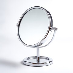 Shiny silver round makeup mirror on a stand isolated on white background
