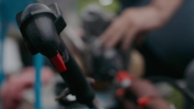 The craftsman disassembles the engine of a lawnmower