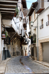 Narrow street with historical houses in the old town of Morella city