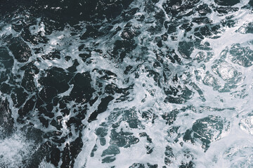 Dynamic ocean waves with foamy patterns and shimmering water surface