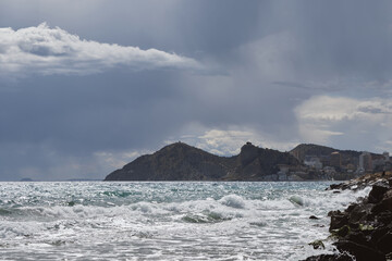 Dramatic coastal landscape with stormy sky and rolling waves