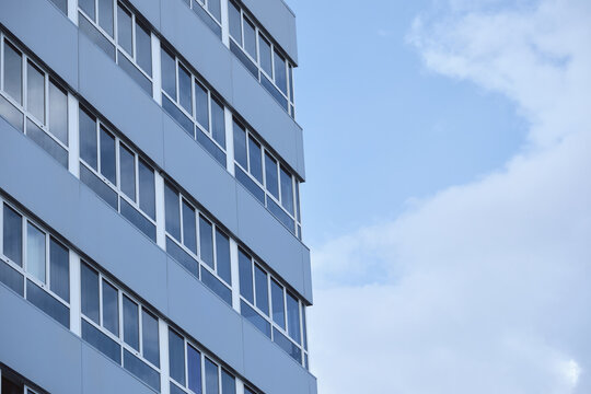 Modern office building against blue sky with rectangular windows