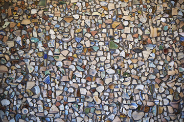 Colorful mosaic wall composed of ceramic shards and patterns creating abstract art
