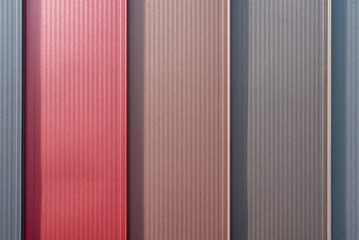 Multicolored Rebated Seam Metal Roof panels in daylight, close up