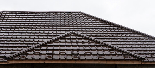 Shiny brown metal tile roof with center rib