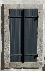 Window with wooden shutters on a house