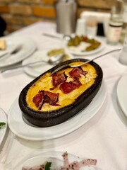 Delicious hot hummus or humus with chickpeas, olive oil, lemon and pita bread.