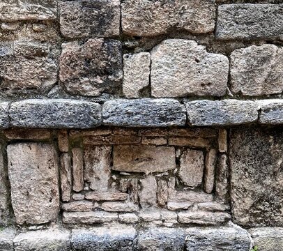 mysterious stone pattern on a wall of an ancient mayan ruin in Mexico
