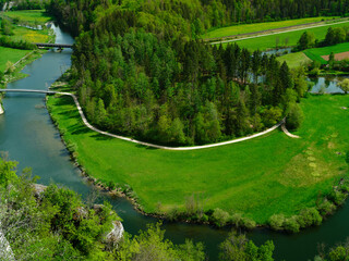 Scenic landscape featuring a river winding through lush greenery in daytime