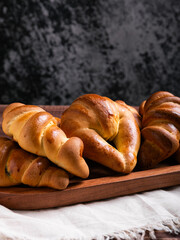 Golden-Brown Croissants on Rustic Wooden Tray. Copy space.