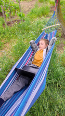 Boy relaxing on picnic during school holidays, family outdoor recreation, camping, summer school holidays. Online learning during holidays