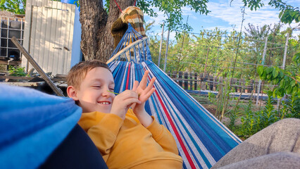 Boy relaxing on picnic during school summer holidays, family outdoor recreation, camping, summer holidays at school