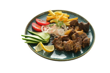 Juicy fried meat in sauce on a plate with French fries, salad, and slices of lemon, tomato, and cucumber — presented on a white background.