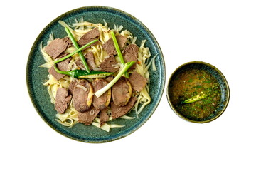 Beshbarmak is a national dish of Central Asia: boiled horse meat, noodles, greens, and a bowl of...