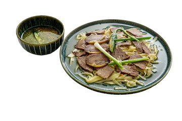 Beshbarmak is a national dish of Central Asia: boiled horse meat, noodles, greens, and a bowl of...