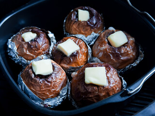Baked apples with butter in foil. Delicious homemade dessert in baking tray
