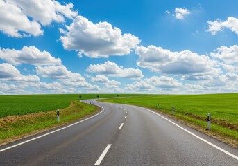 Scenic road through field under sky