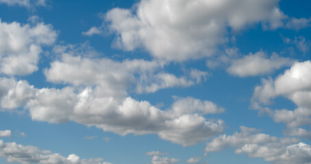 heaven sky is blue with a few clouds scattered throughout. The clouds are white and fluffy, giving the sky a peaceful and serene.