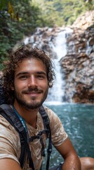 Man smiles at waterfall