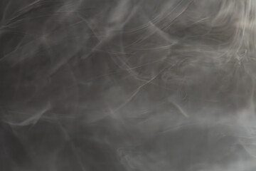 A stylized image with abstract shapes resembling smoke or water droplets, creating an ethereal, mysterious atmosphere It appeals to a sophisticated audience seeking open interpretation