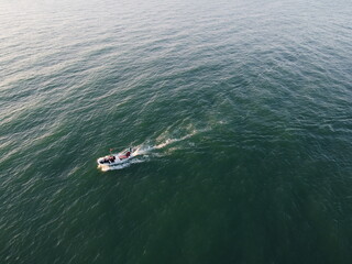 fishermen pass by on a speedboat