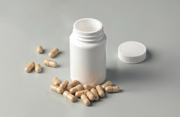 Lion Mane mushroom vegetarian capsules near bottle. Dietary supplement pills for brain health, focus, memory. Natural nootropics, medicinal mushroom product, holistic medicine, healthy lifestyle.