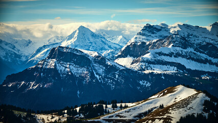 Majestic snow-capped mountains under a clear sky in the Swiss Alps during winter