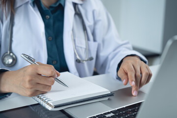 Fototapeta premium Medical student using laptop computer in research education. Internship doctor searching the information at doctor's office, medical research. Healthcare and medicine, closeup