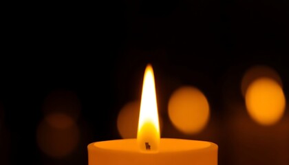 lit candle in a dark room with blurry lights