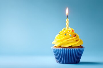 Vibrant cupcake with candle against a blue backdrop.