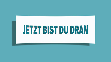 Jetzt bist du dran (Now it's your turn) - A card isolated on light green background.