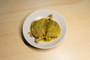 A plate of braised duck leg with green chilli sauce.