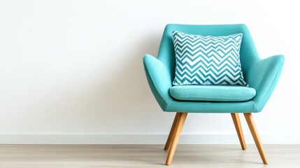 Modern turquoise armchair with decorative pillow in minimalist interior setting