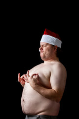 A man is standing in a black background with his hands on his chest