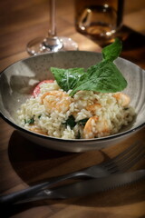 Risotto with arugula and shrimp, an Italian classic on a plate
