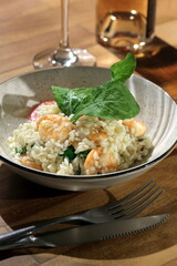 Risotto with arugula and shrimp, an Italian classic on a plate