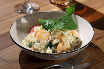 Risotto with arugula and shrimp, an Italian classic on a plate