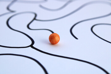 A leading sphere seeks a way out of a maze