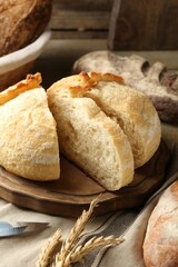 Cut freshly baked bread, spikes and knife on table, closeup