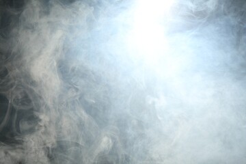 Beautiful smoke in lights on dark background