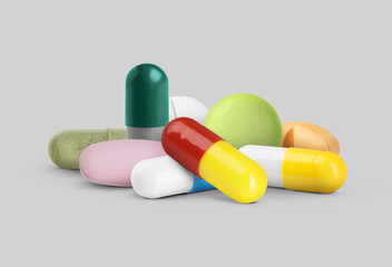 Many different antibiotic pills on grey background