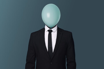 Businessman with balloon instead of his head on blue grey background
